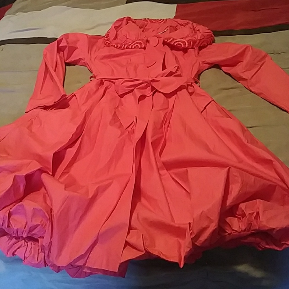 A dress up pink/red jacket with frill and pockets